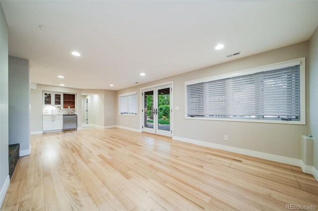 unfurnished living room featuring baseboards, light wood-style floors, and recessed lighting
