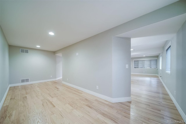 unfurnished room with recessed lighting, light wood-type flooring, and baseboards