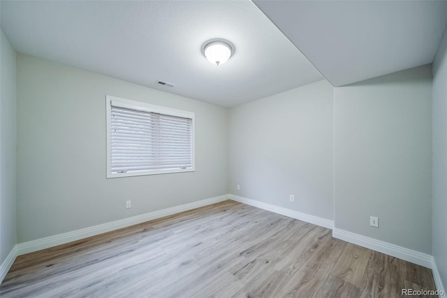 unfurnished room featuring wood finished floors and baseboards
