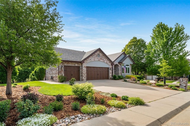 4532 Christensen Cir, Littleton, CO 80123 - view of front facade featuring stone siding, an attached garage, concrete driveway, a front lawn, and a tiled roof