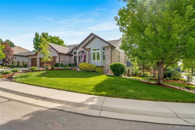 4532 Christensen Cir, Littleton, CO 80123 - view of front of home featuring an attached garage, a front yard, brick siding, and concrete driveway