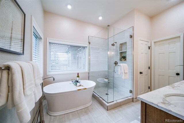 4532 Christensen Cir, Littleton, CO 80123 - full bath with a freestanding tub, a shower stall, double vanity, and recessed lighting