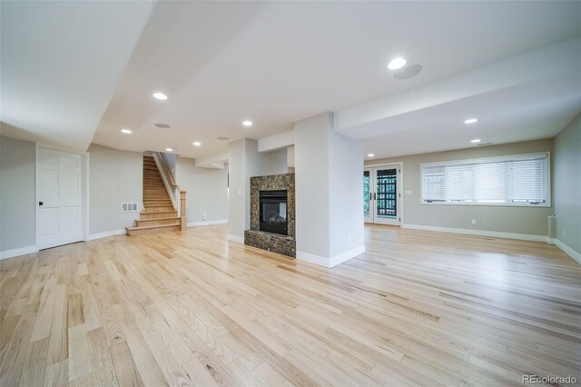 4532 Christensen Cir, Littleton, CO 80123 - unfurnished living room with light wood-style floors, stairway, a fireplace, baseboards, and recessed lighting