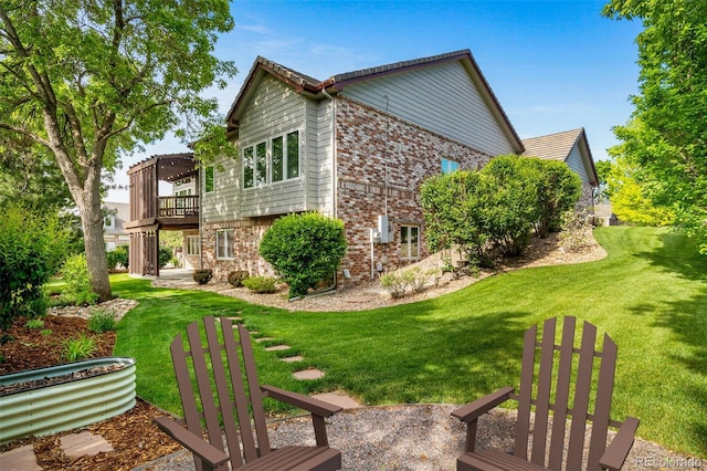 4532 Christensen Cir, Littleton, CO 80123 - view of side of property featuring brick siding, a yard, and a wooden deck