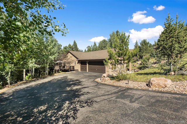 view of front facade featuring asphalt driveway and an attached garage