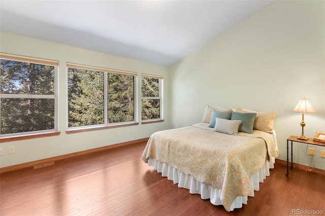 bedroom featuring lofted ceiling and wood-type flooring