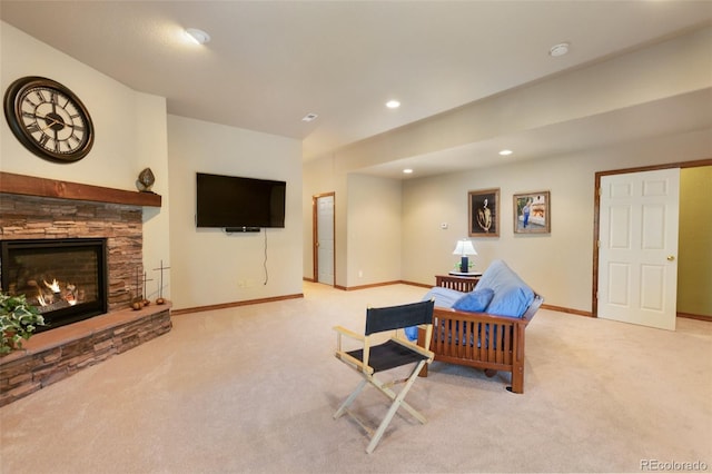carpeted living area with recessed lighting and a fireplace