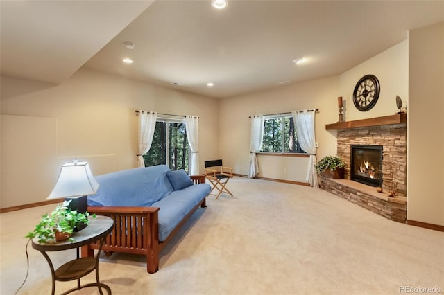 carpeted living area featuring a fireplace and recessed lighting