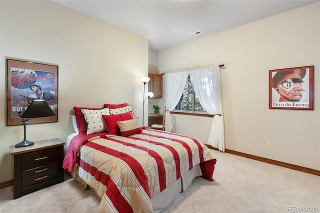 bedroom featuring light carpet and baseboards