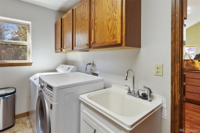 washroom with washer and dryer and cabinet space