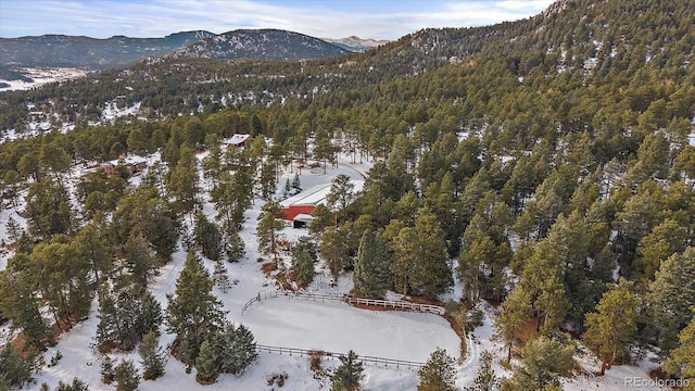 snowy aerial view with a mountain view