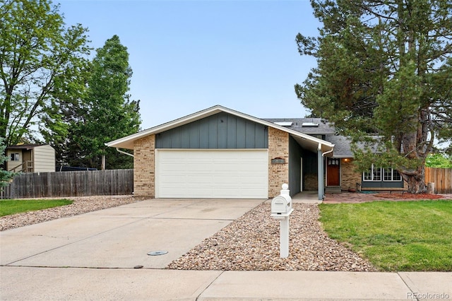 2495 S Lansing Way, Aurora, CO 80014 - view of front of property with brick siding, a garage, and driveway