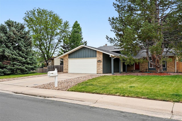 2495 S Lansing Way, Aurora, CO 80014 - view of front of house with brick siding, an attached garage, driveway, and board and batten siding