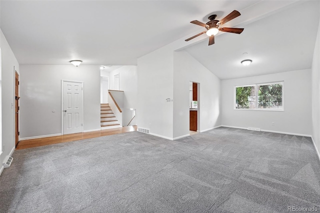 2495 S Lansing Way, Aurora, CO 80014 - carpeted empty room with ceiling fan, baseboards, vaulted ceiling, and stairway