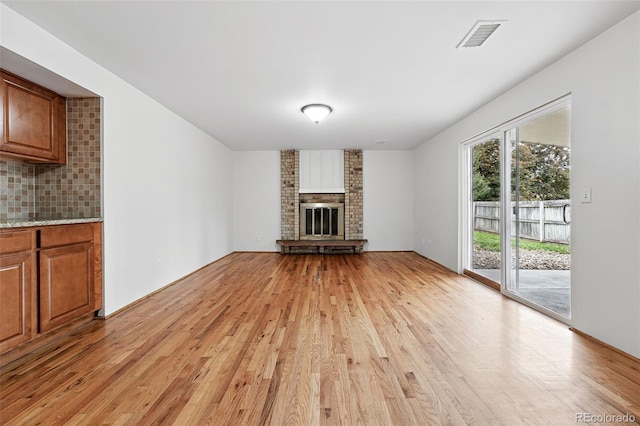 2495 S Lansing Way, Aurora, CO 80014 - unfurnished living room featuring light wood-style floors and a fireplace