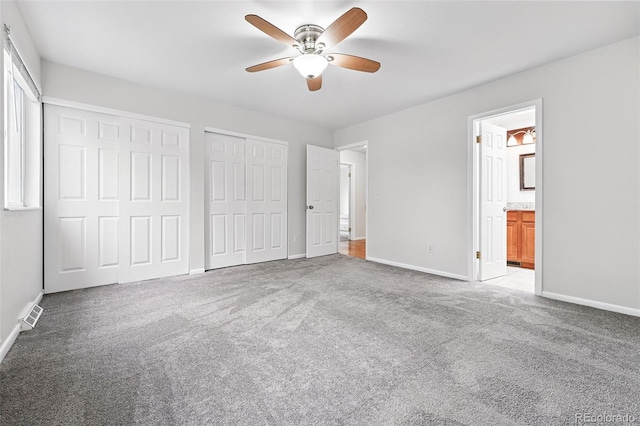 2495 S Lansing Way, Aurora, CO 80014 - unfurnished bedroom featuring multiple closets, light carpet, and baseboards