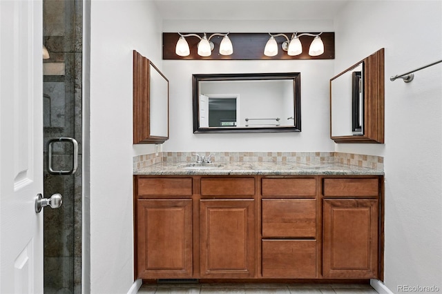 2495 S Lansing Way, Aurora, CO 80014 - bathroom featuring a stall shower, vanity, and baseboards