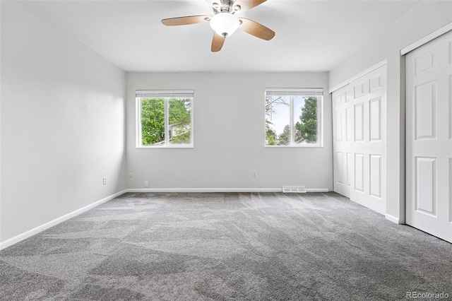 2495 S Lansing Way, Aurora, CO 80014 - unfurnished bedroom with carpet flooring, baseboards, ceiling fan, and multiple closets