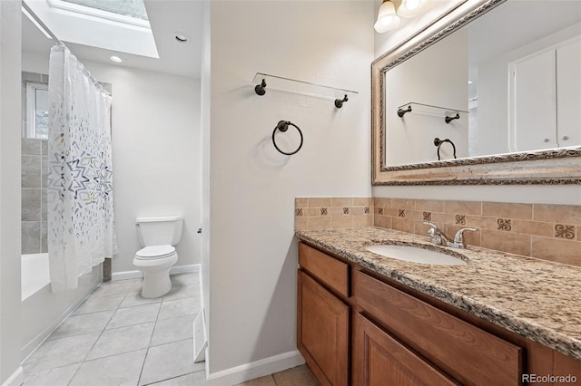2495 S Lansing Way, Aurora, CO 80014 - full bath with a skylight, vanity, toilet, tile patterned flooring, and backsplash