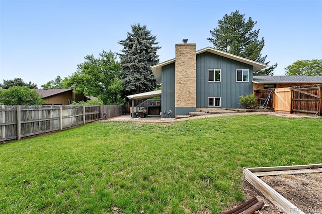 2495 S Lansing Way, Aurora, CO 80014 - rear view of house with board and batten siding, a chimney, and a patio
