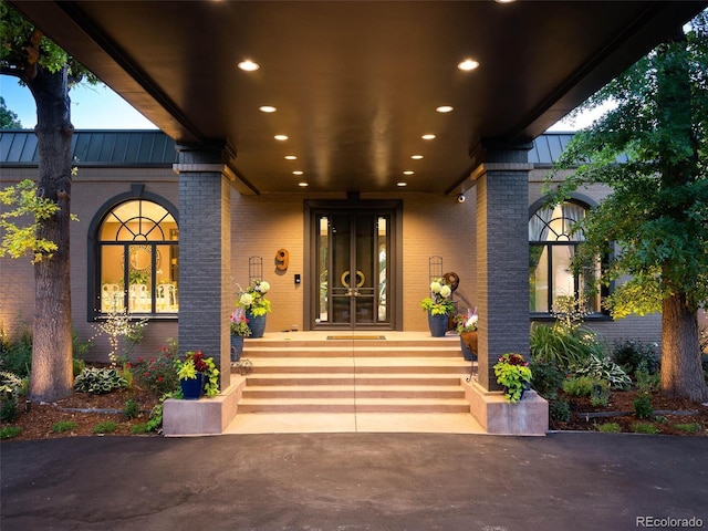 9 Sedgwick Dr, Englewood, CO 80113 - entrance to property featuring a standing seam roof, brick siding, a porch, and a metal roof