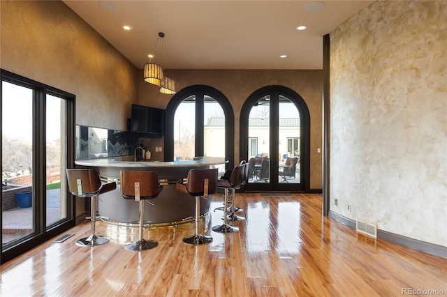 9 Sedgwick Dr, Englewood, CO 80113 - bar with light wood-style floors, recessed lighting, and decorative light fixtures