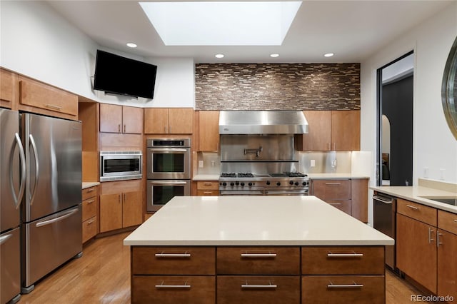 9 Sedgwick Dr, Englewood, CO 80113 - kitchen with stainless steel appliances, ventilation hood, backsplash, light wood-type flooring, and recessed lighting