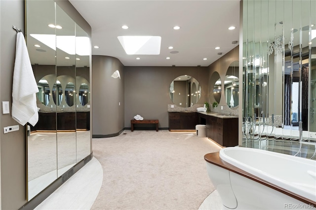 9 Sedgwick Dr, Englewood, CO 80113 - full bathroom with a tub, vanity, a skylight, and recessed lighting