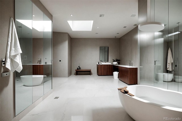 9 Sedgwick Dr, Englewood, CO 80113 - bathroom featuring a freestanding tub, vanity, and a skylight