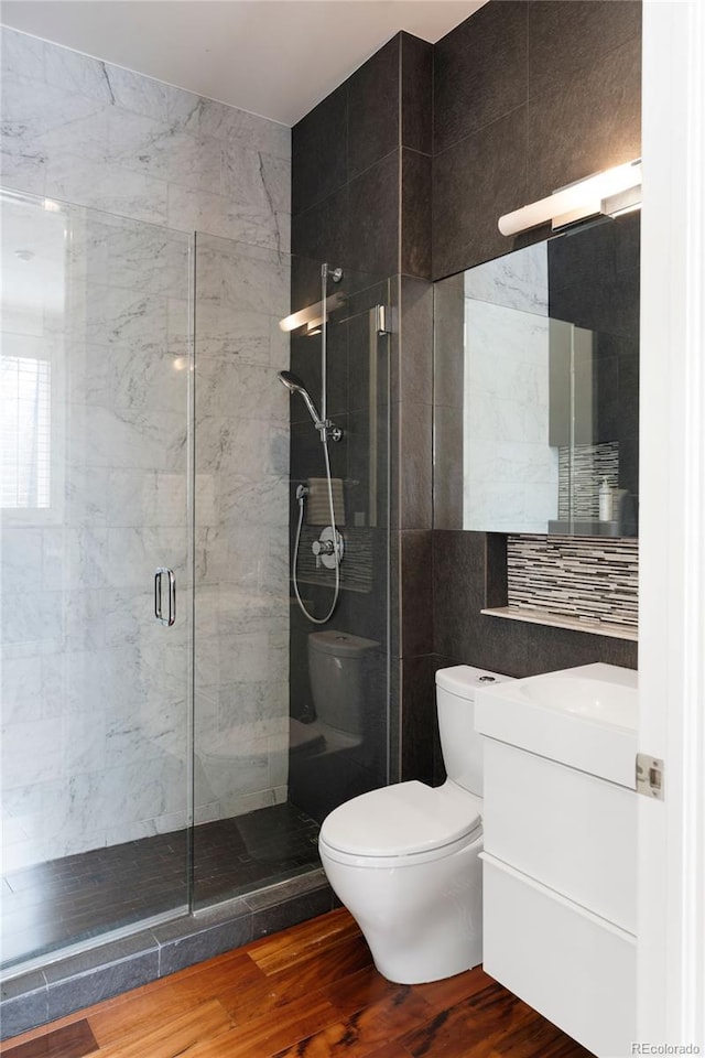 9 Sedgwick Dr, Englewood, CO 80113 - full bath with vanity, a stall shower, wood finished floors, and tile walls
