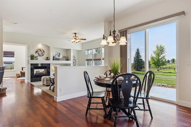 5605 Killen Ave, Castle Rock, CO 80104 - dining space featuring plenty of natural light, wood finished floors, a tiled fireplace, and a chandelier