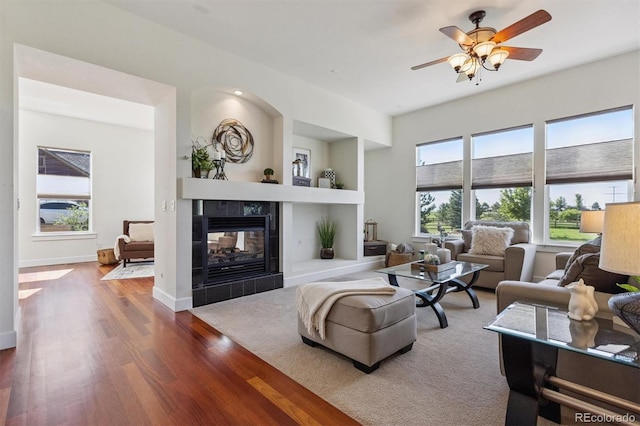 5605 Killen Ave, Castle Rock, CO 80104 - living area with wood finished floors, a tile fireplace, and a ceiling fan