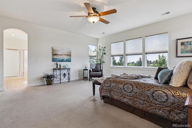 5605 Killen Ave, Castle Rock, CO 80104 - carpeted bedroom featuring arched walkways, connected bathroom, and ceiling fan