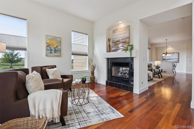 5605 Killen Ave, Castle Rock, CO 80104 - living area with wood finished floors, a tiled fireplace, and a chandelier