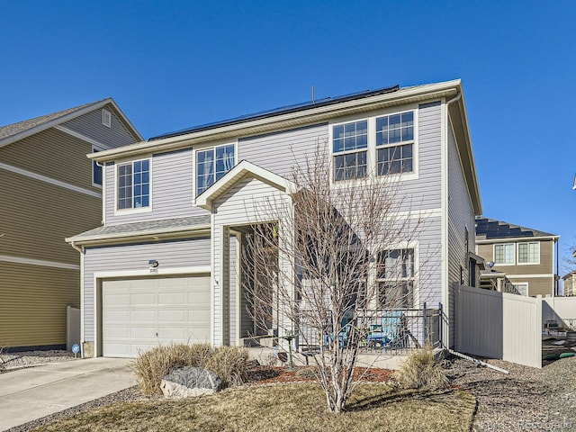 front of property with a garage and solar panels