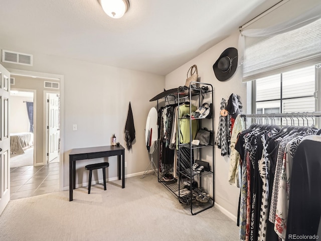 spacious closet featuring light carpet