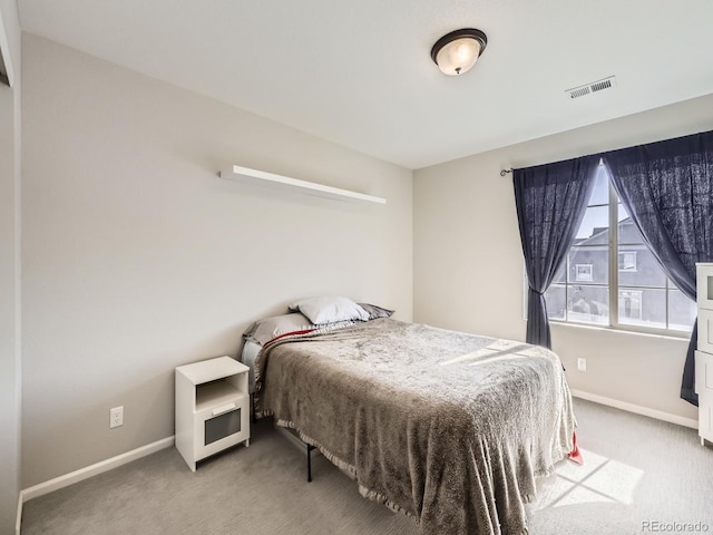 bedroom featuring light carpet