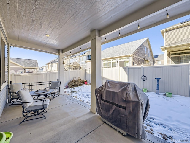 snow covered patio with area for grilling