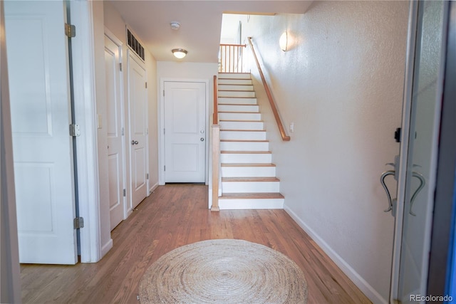 451 S Reed St, Lakewood, CO 80226 - foyer with wood finished floors, baseboards, and stairway