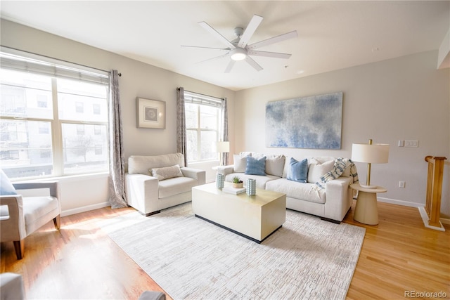 451 S Reed St, Lakewood, CO 80226 - living area featuring light wood-style flooring, a ceiling fan, and baseboards