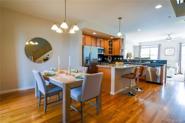 451 S Reed St, Lakewood, CO 80226 - dining area with light wood-style flooring, a chandelier, recessed lighting, baseboards, and ceiling fan
