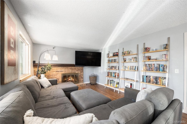 4844 E 110th Pl, Thornton, CO 80233 - living room featuring wood finished floors, a textured ceiling, and a brick fireplace