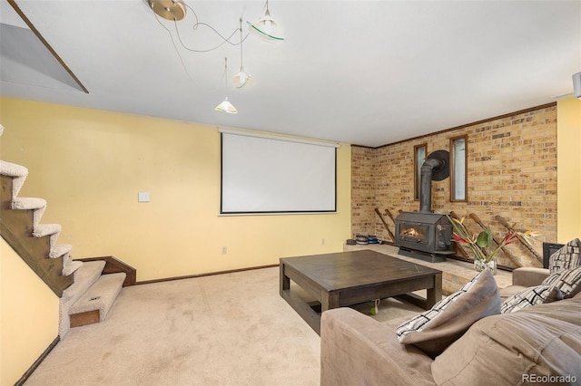 4844 E 110th Pl, Thornton, CO 80233 - carpeted home theater room featuring a wood stove and brick wall