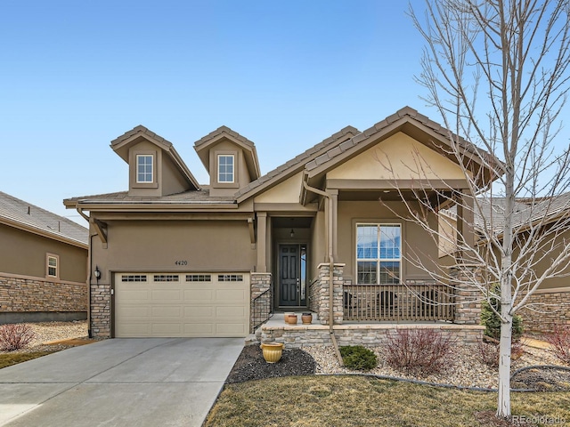 craftsman inspired home featuring driveway, a porch, an attached garage, stucco siding, and stone siding