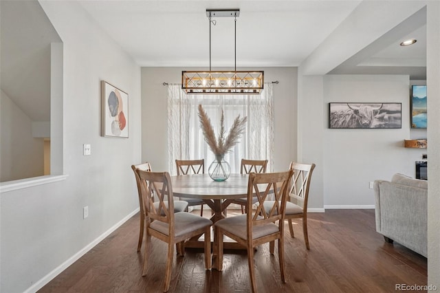 18079 E 108th Pl, Commerce City, CO 80022 - dining space featuring baseboards, dark wood finished floors, and a chandelier