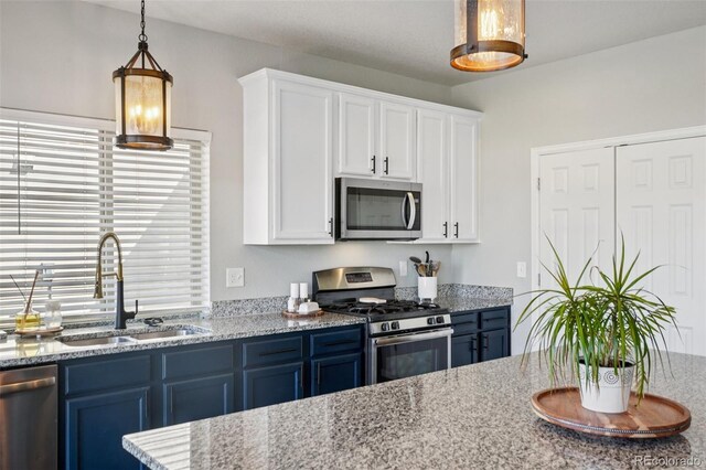 18079 E 108th Pl, Commerce City, CO 80022 - kitchen featuring stainless steel appliances, a sink, blue cabinetry, and white cabinetry
