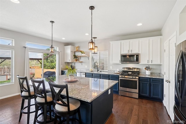 18079 E 108th Pl, Commerce City, CO 80022 - kitchen featuring stainless steel appliances, a sink, recessed lighting, white cabinetry, and open shelves