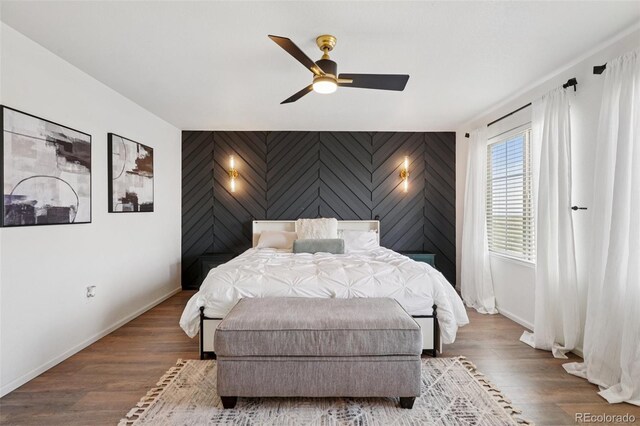 18079 E 108th Pl, Commerce City, CO 80022 - bedroom featuring an accent wall, baseboards, and wood finished floors