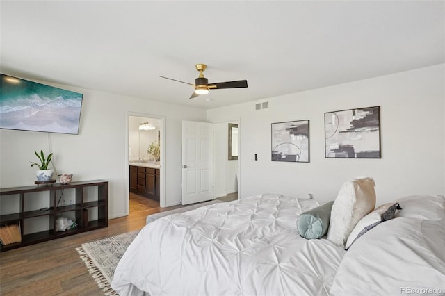 18079 E 108th Pl, Commerce City, CO 80022 - bedroom with wood finished floors, ensuite bath, and a ceiling fan