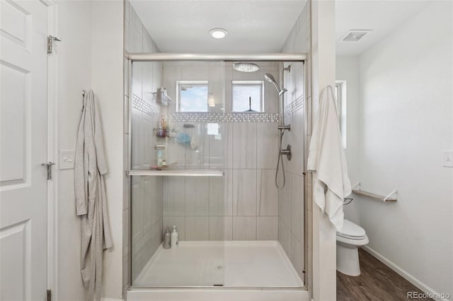 18079 E 108th Pl, Commerce City, CO 80022 - full bathroom with toilet, baseboards, a shower stall, and wood finished floors